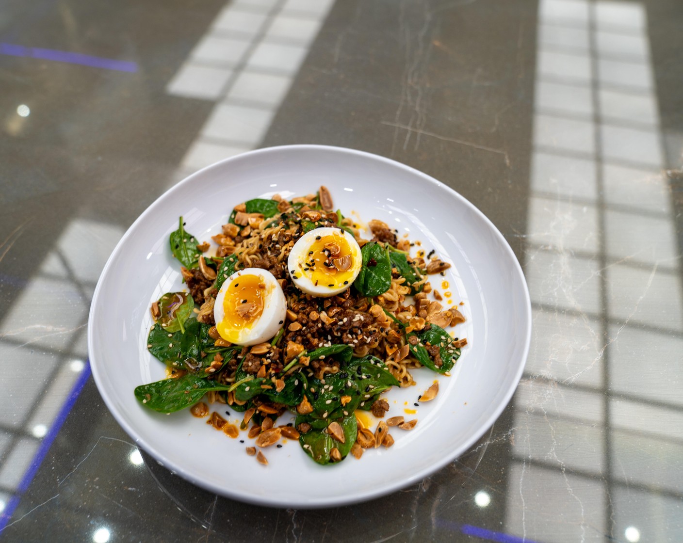 step 7 Serve the stir-fry topped with a soft-boiled egg, Toasted White Sesame Seeds (2 tsp), Roasted Peanuts (1/2 cup), scallion greens, and Chili Oil (to taste).