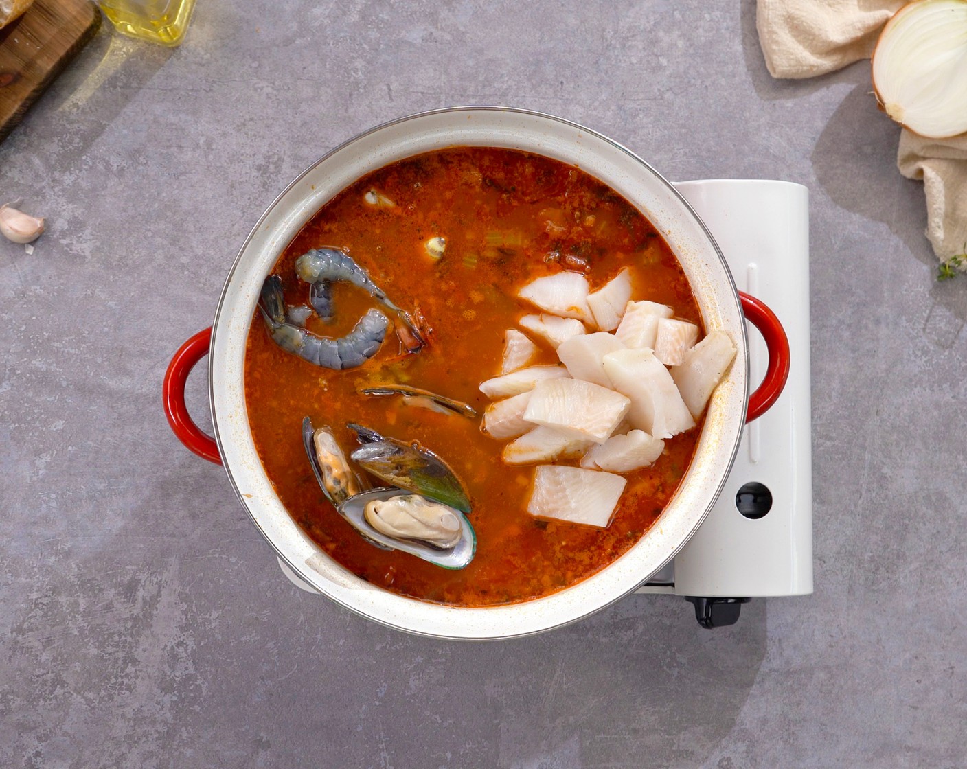 step 6 Add the Shrimp (10 oz), Fresh Mussels (8 oz), Fresh Clams (8 oz), and halibut pieces to the soup. When the soup starts to boil, skim off the scrum and foam. Let it simmer for 5 minutes, or until the seafood is all cooked.
