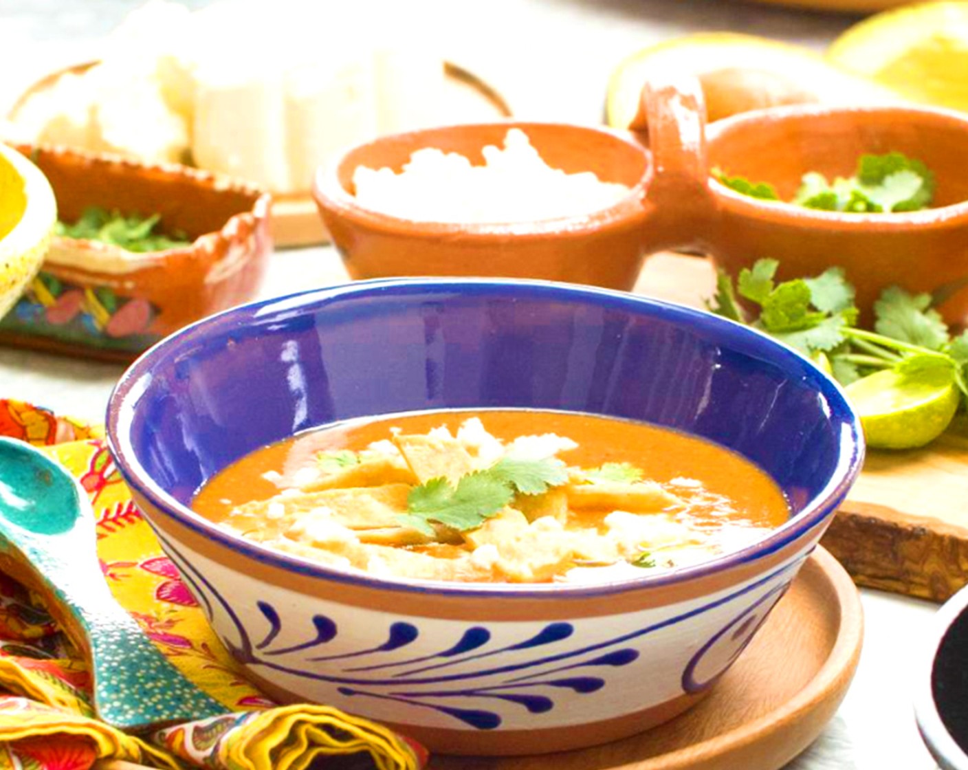 step 22 Ladle soup into bowls and top with Queso Fresco (to taste) Avocado (1) and Fresh Cilantro (to taste) Dash with Hot Sauce (to taste) if using, then a generous squeeze of Lime Wedges (to taste) over everything. Top with crispy tortilla strips and serve alongside the quesadillas.