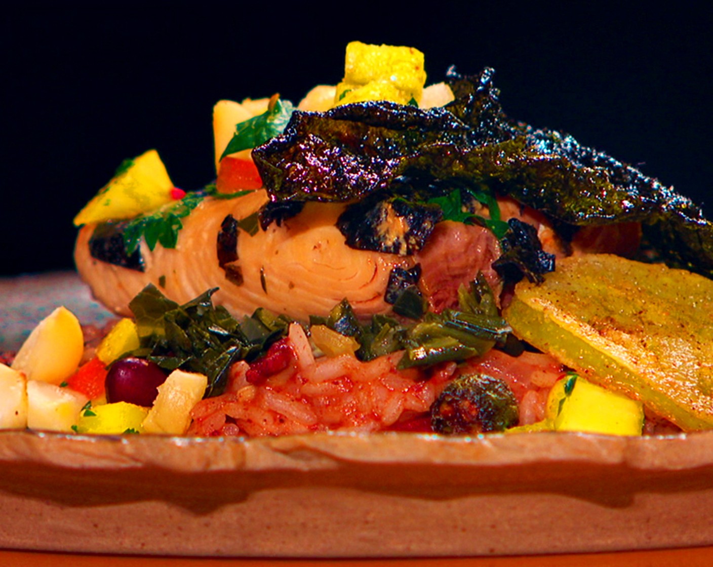 step 14 Assembly: Spoon the rice and collard greens onto a plate, unwrap the fish, and lay on top. Garnish with the salsa, a slice of fried green tomato, and a piece of Nori Sheet (1).