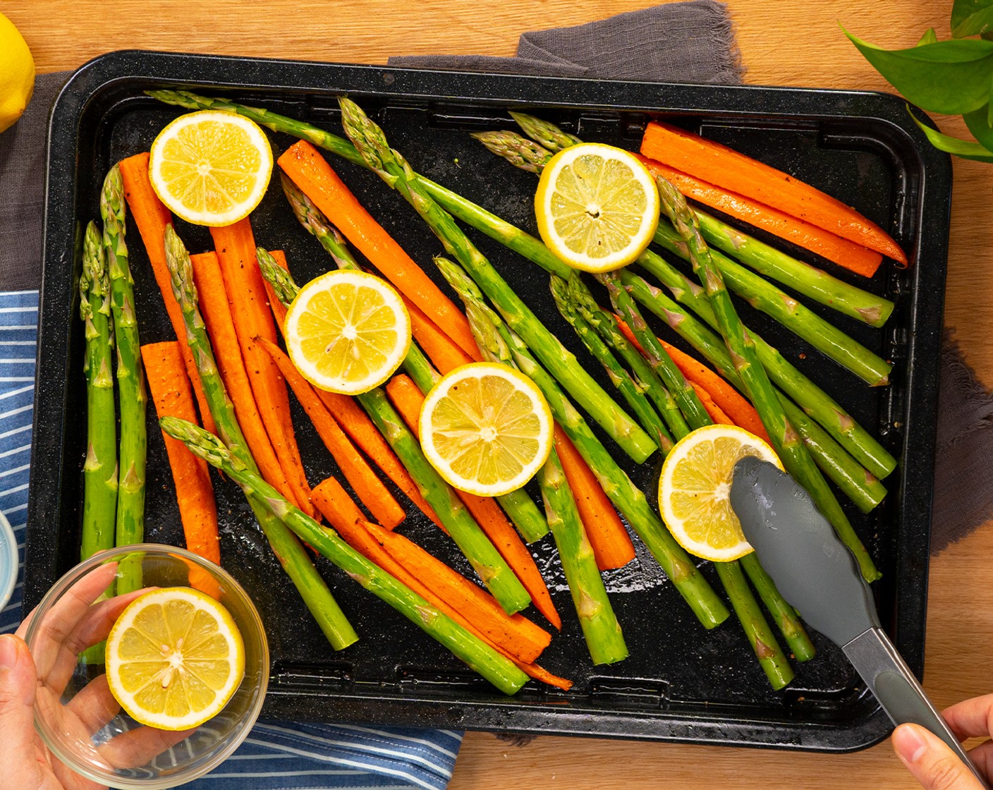 step 3 Remove the tray from the oven, then add the Asparagus (1 bunch) and Lemon Slice (1) to the baking tray and toss so that the asparagus is fully coated in oil. And bring it back to the oven for 5-10 more minutes, or until the vegetables are tender and slightly browned. Set aside.
