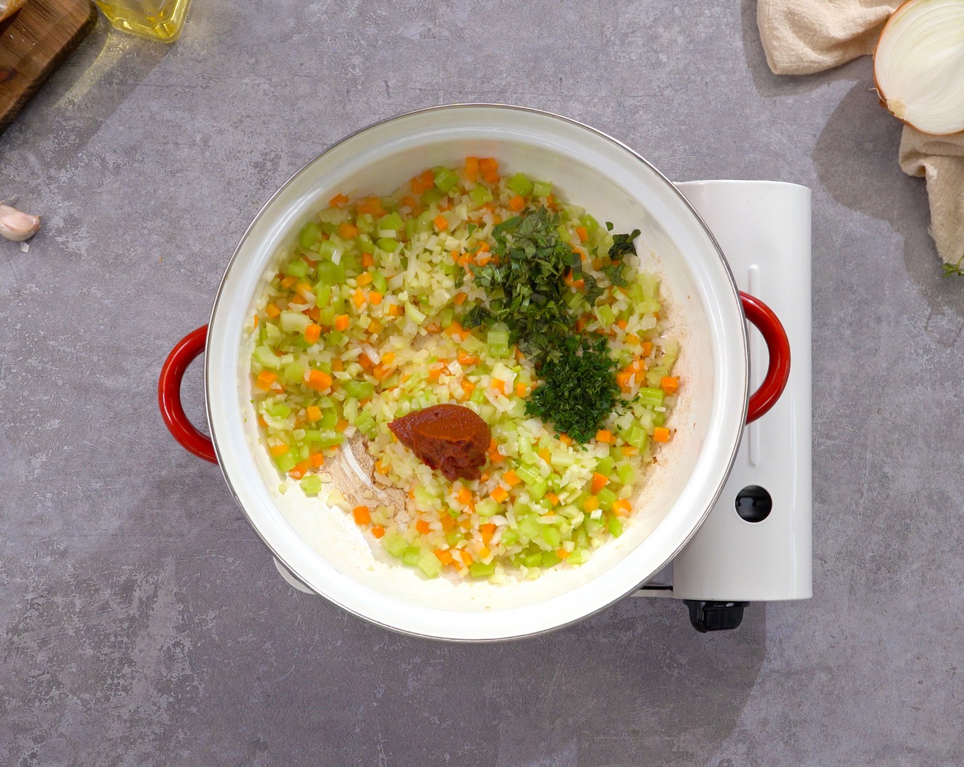 step 3 Add Fresh Basil (1 Tbsp), Fresh Parsley (1 Tbsp), and Tomato Paste (2 Tbsp). Stir occasionally and cook for about 2 minutes, until the paste becomes thick and dark.
