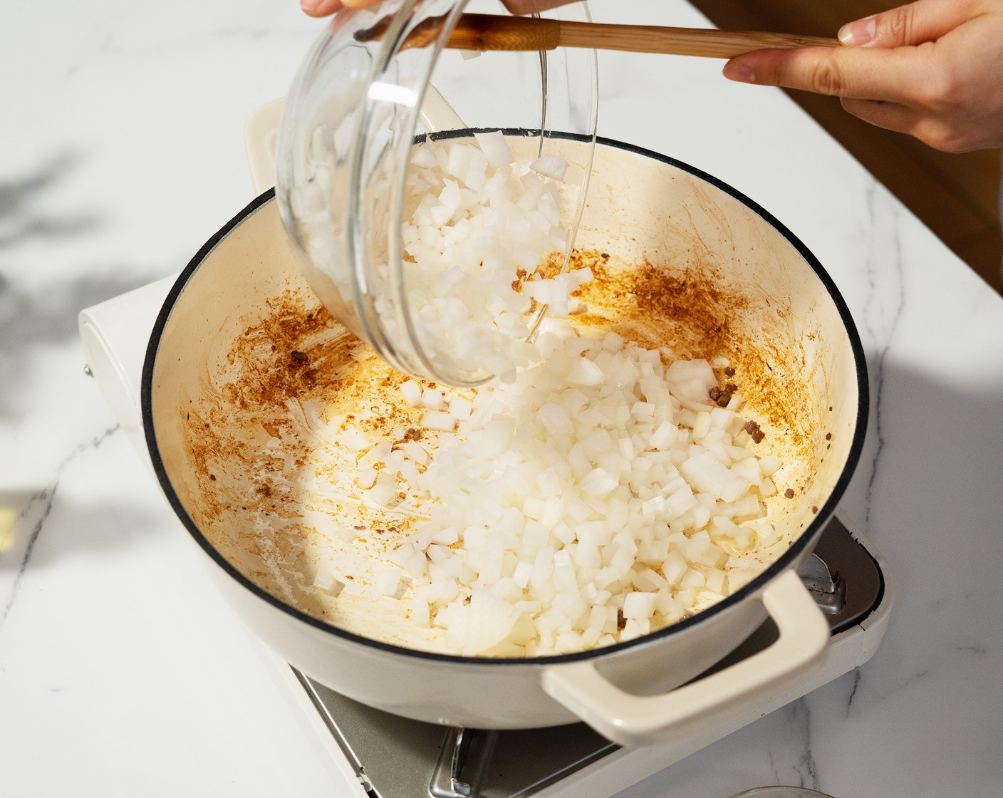 step 2 To the same pot, add the Yellow Onion (1) and Garlic (3 cloves). Cook until the onions have softened.