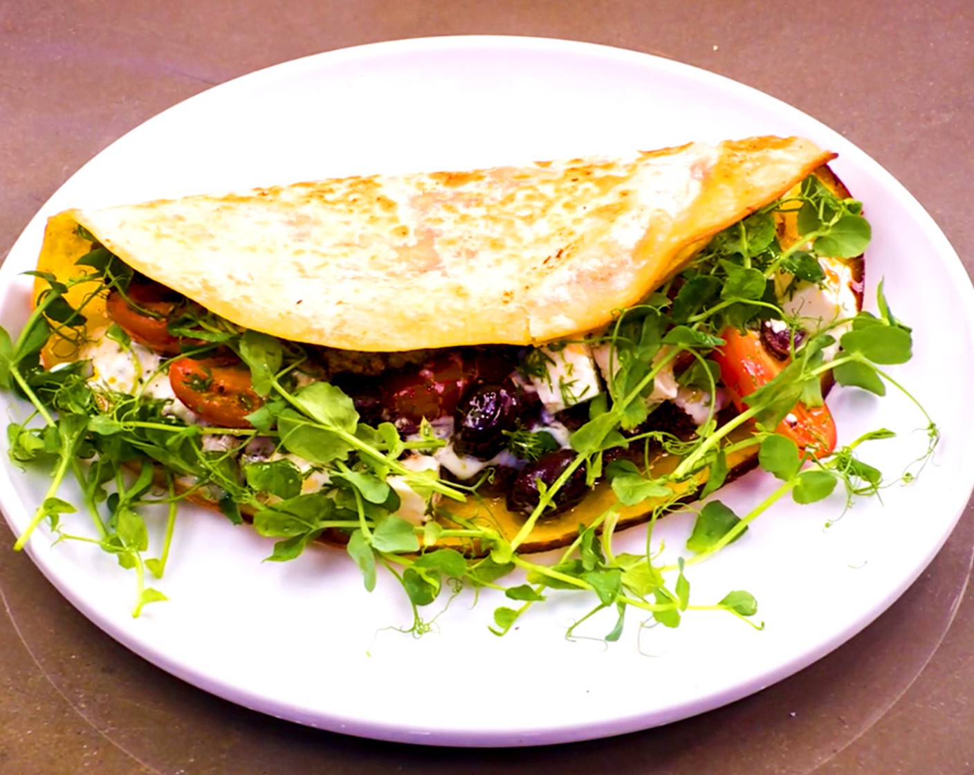 step 7 Assemble: Top the burgers with tzatziki and salad and finish with Pea Shoots (to taste).