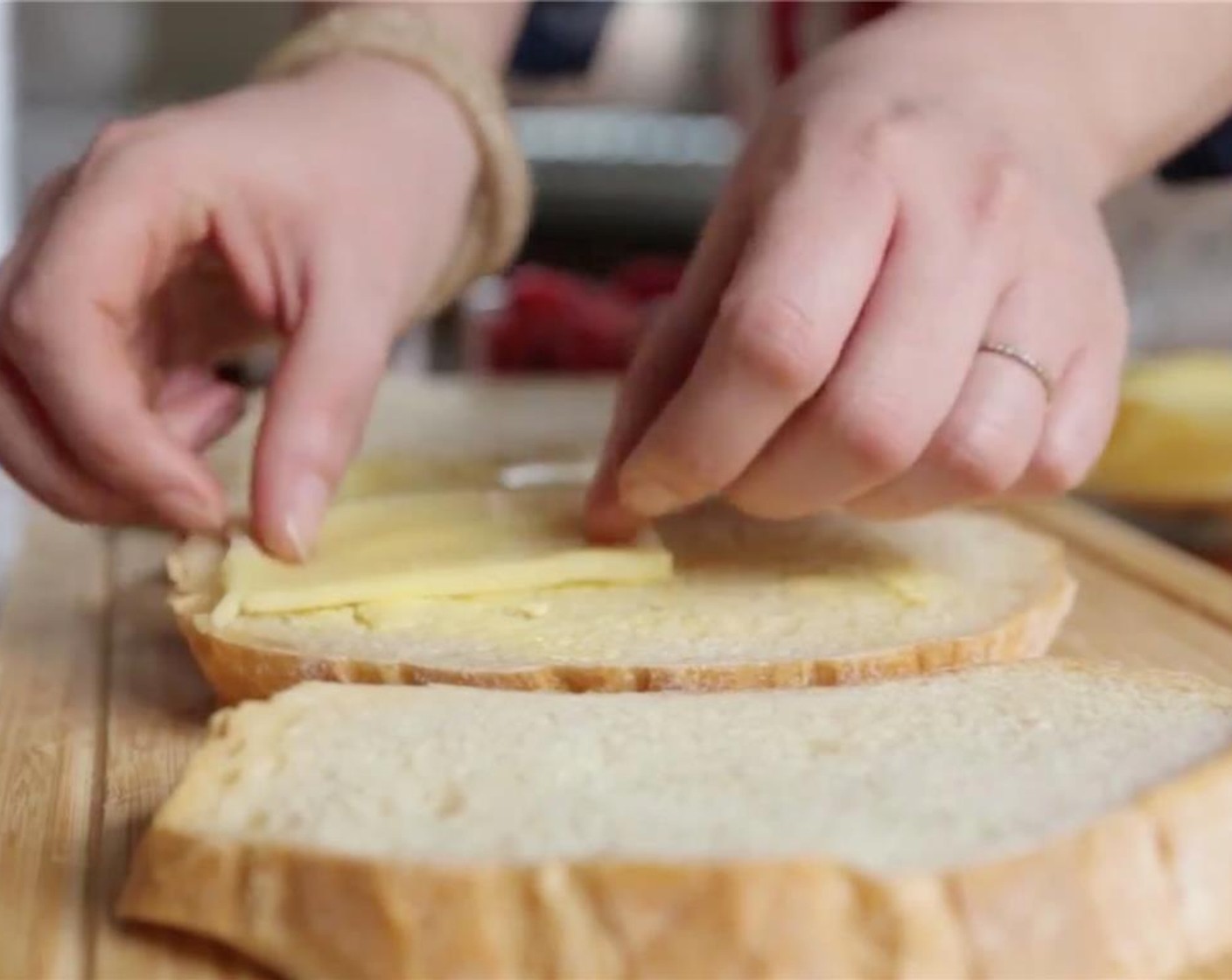 step 3 Place butter side down on the cutting board. Top unbuttered side of the bread with American Cheese Slices (3).