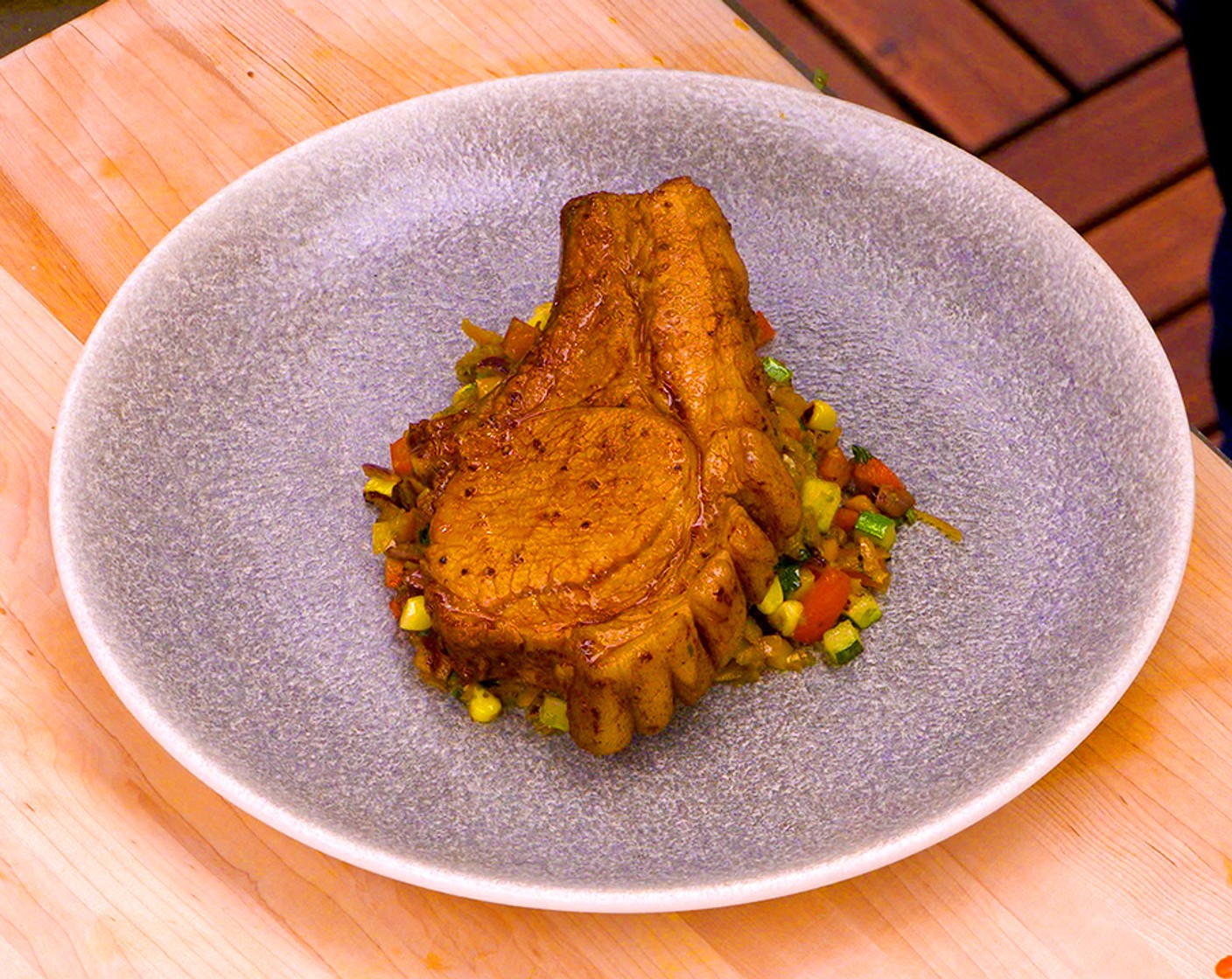 step 10 Serve the grilled pork chop sliced over the succotash and drizzle with the pan sauce from the chop.