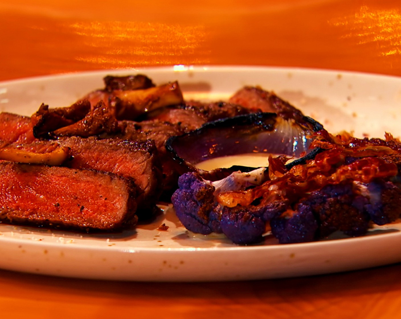Seared Strip Steak with Roasted Purple Cauliflower, Crispy Iberico Ham and Red Onion Petals
