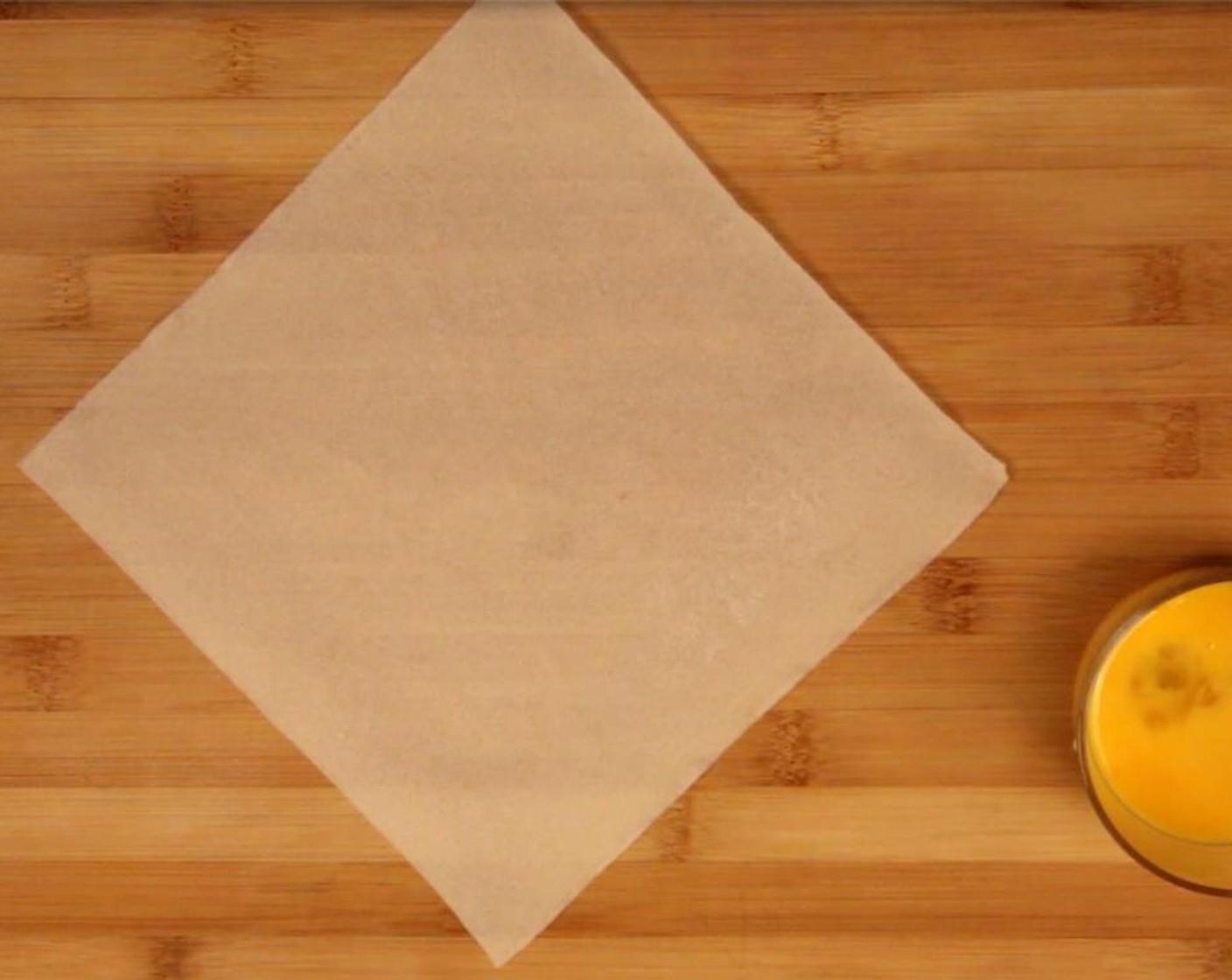 step 2 Beat the Egg (1) in a separate bowl. Lay out one of the Spring Roll Wrappers (12).