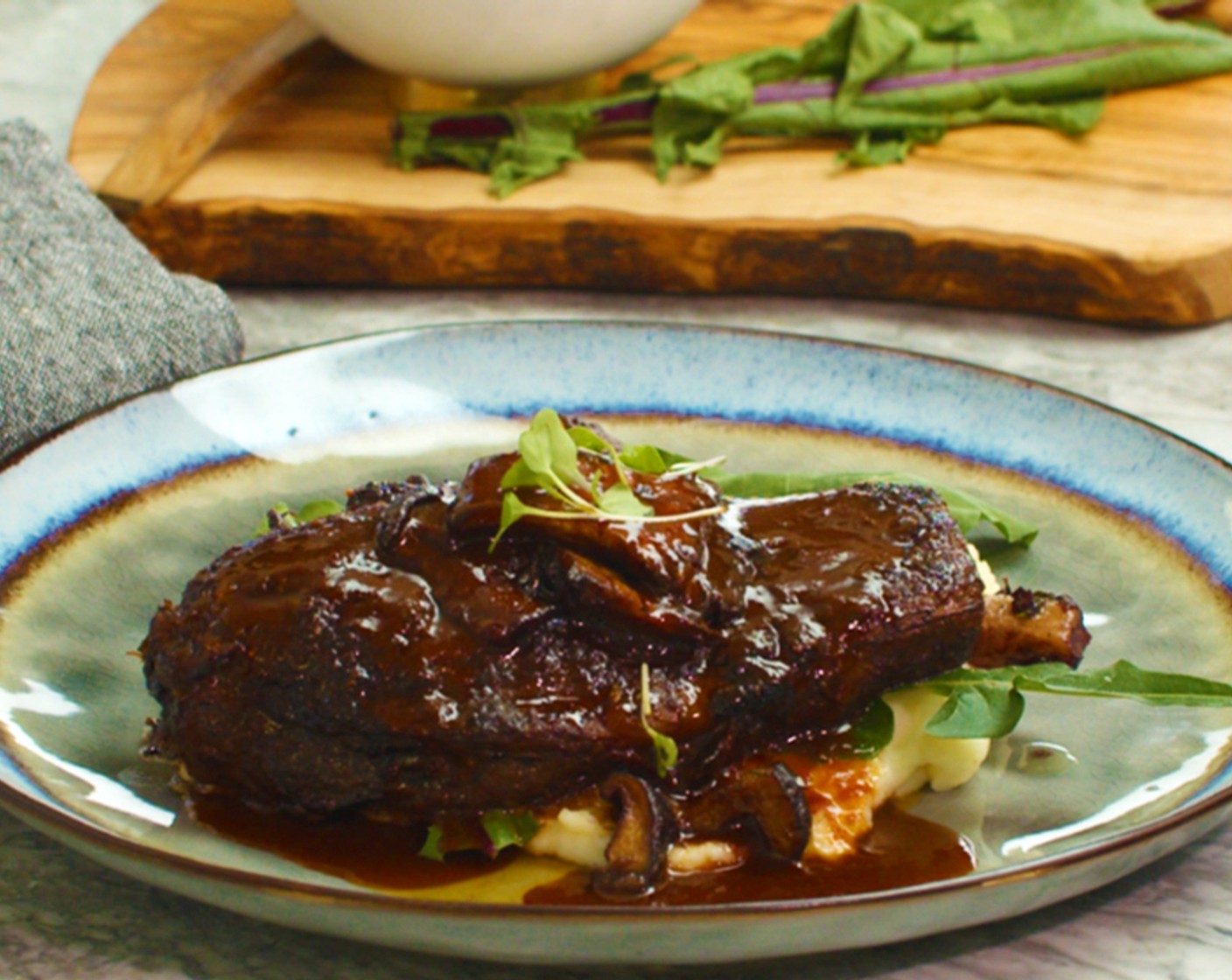 step 28 Serve steaks atop a heaping spoonful of creamy mashed potatoes, spooning glazed mushrooms around steak and a hefty drizzle of charred vegetable demi glace.