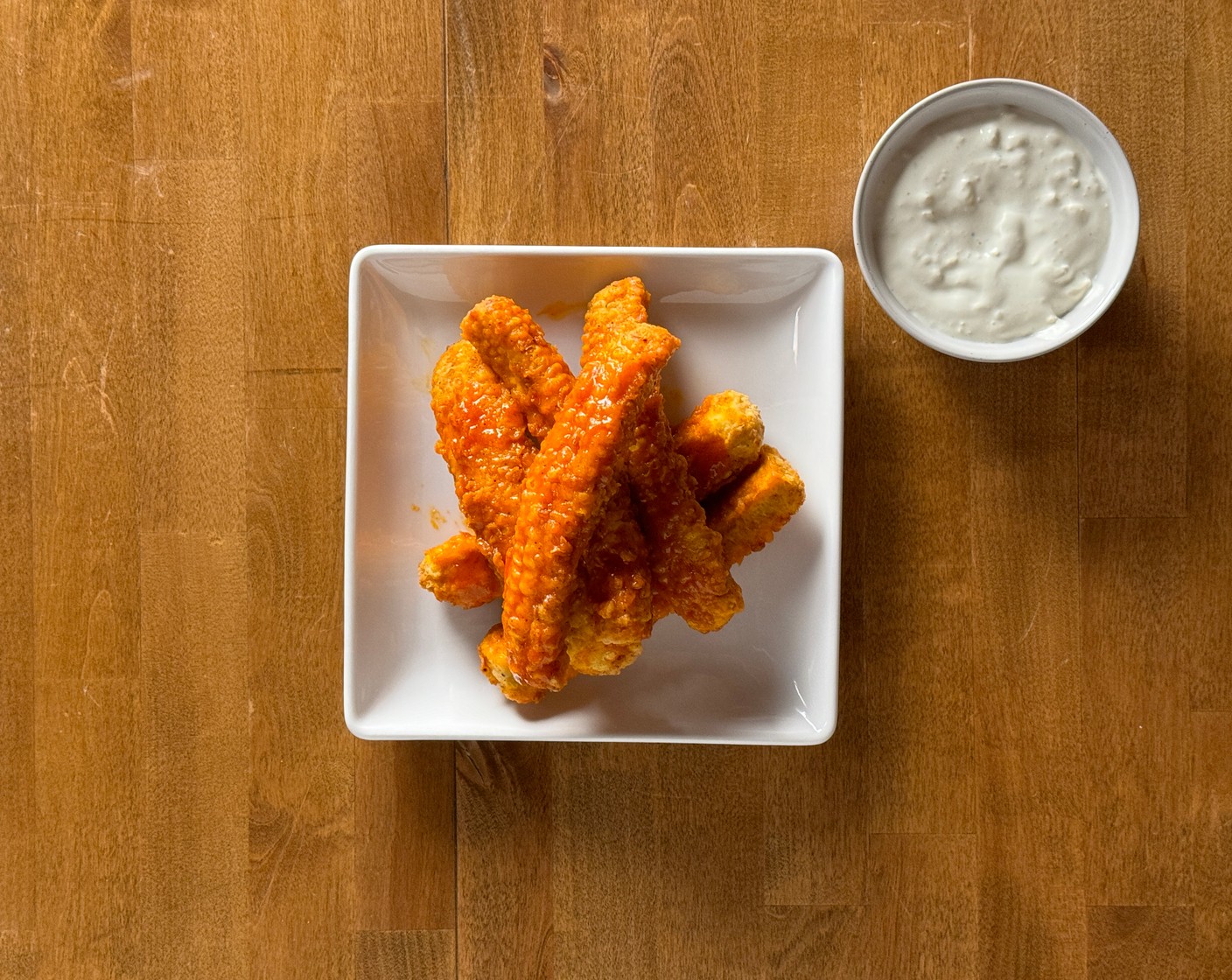 step 7 Serve: Arrange the Buffalo corn ribs on a serving plate and serve immediately with bleu cheese dipping sauce on the side.
